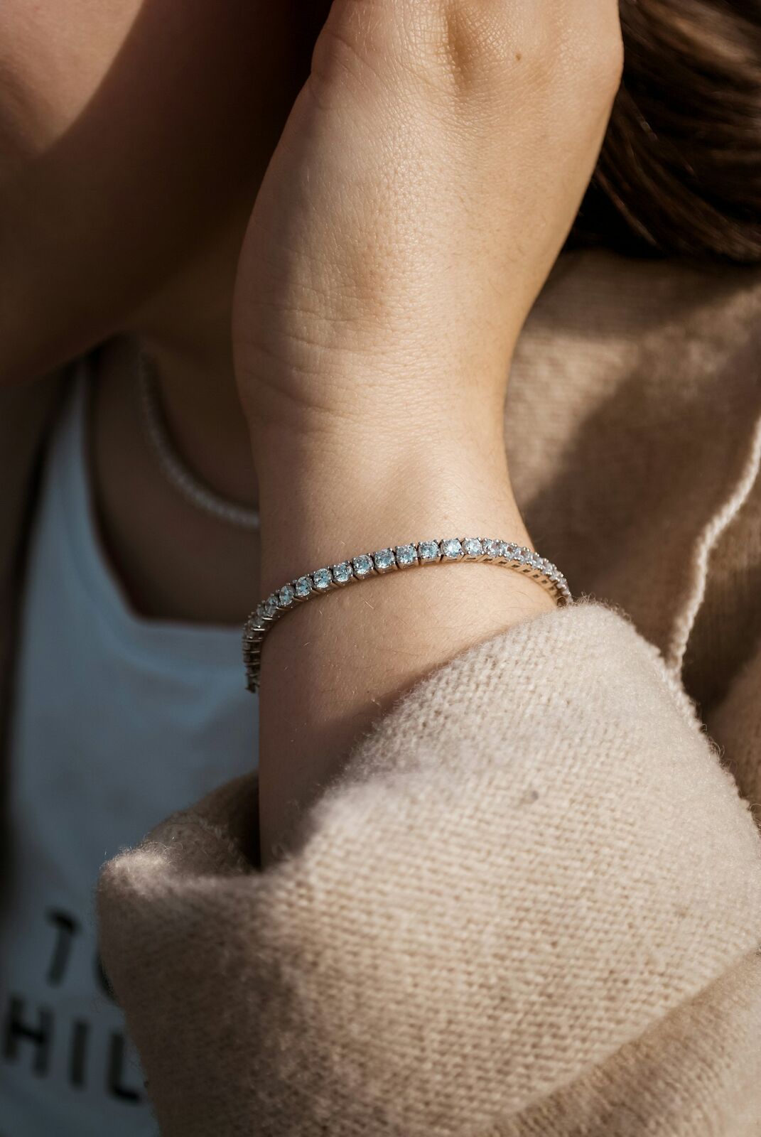 Diamond tennis bracelet worn on a wrist