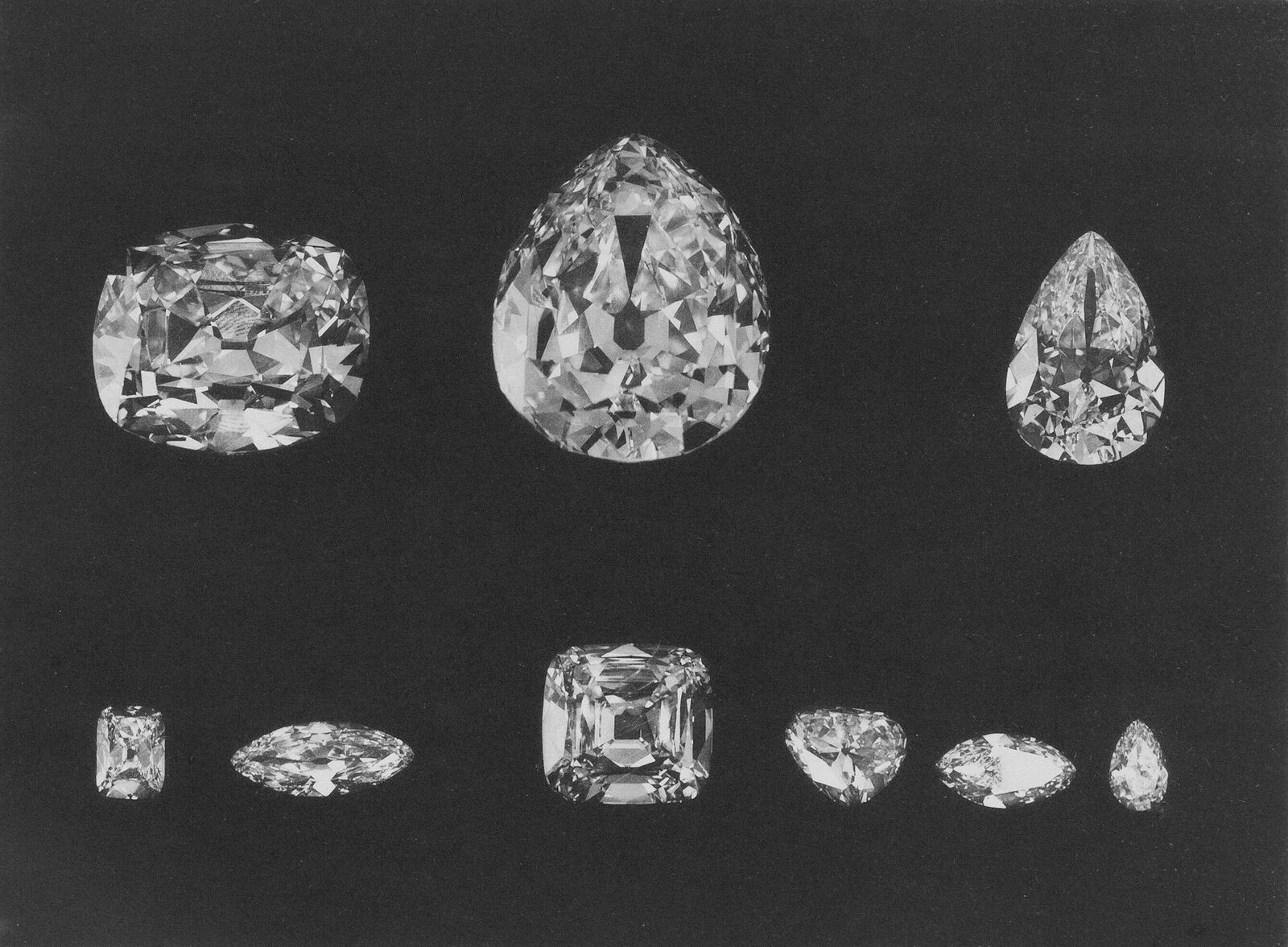 Diamonds of various cuts on dark grey