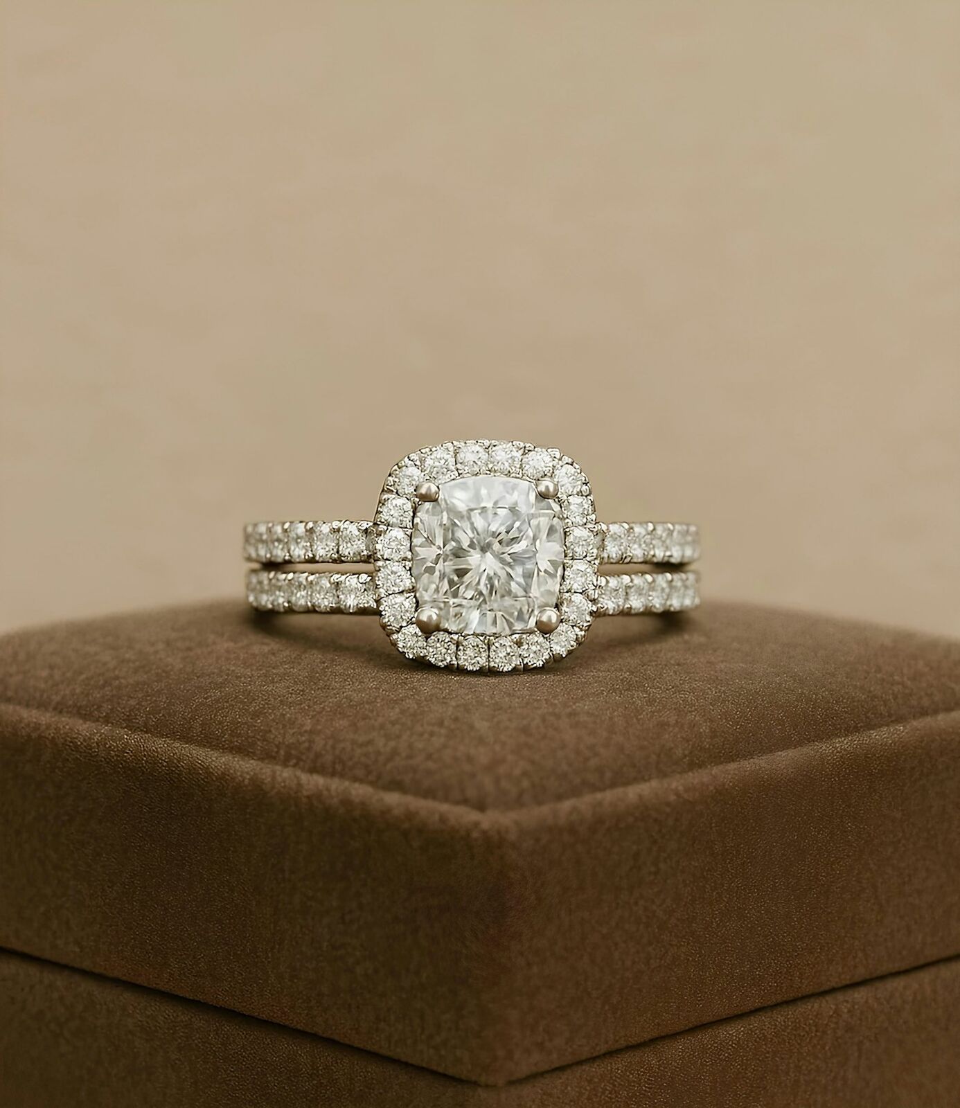 Cushion halo ring with matching band on a brown box
